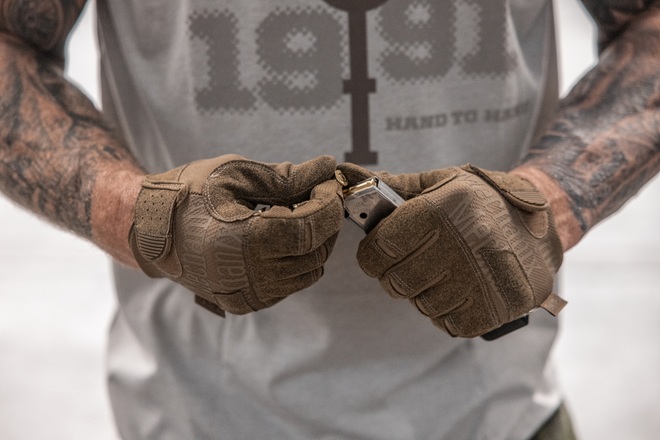 person wearing mechanix gloves